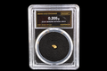 0.205g Australian gold nugget labeled 23.5K in Sierra Gold Exchange slab SGE-2026-00123 on a black background